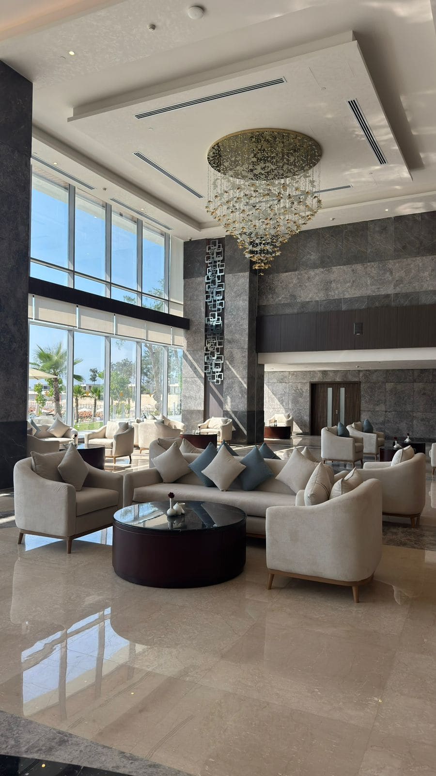 The double-height lobby lounge at Rixos Montaza, with the chandelier and marble floor