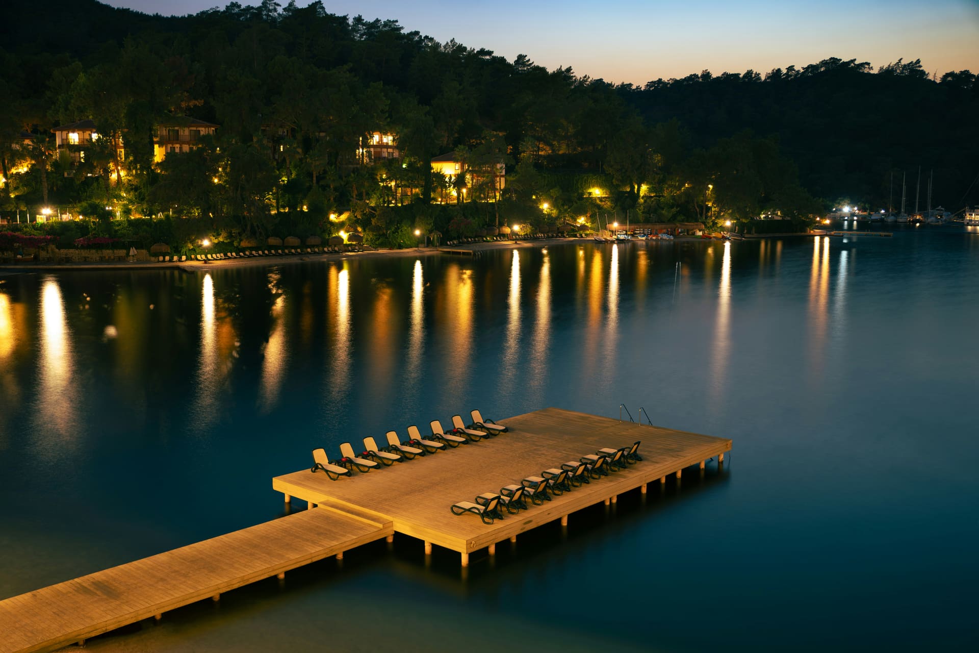 An outdoor lounge by the sea at dusk