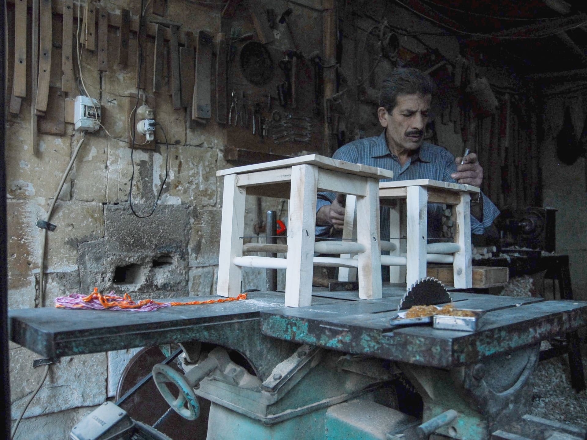 A craftsman finishing a walnut counter in a joinery workshop